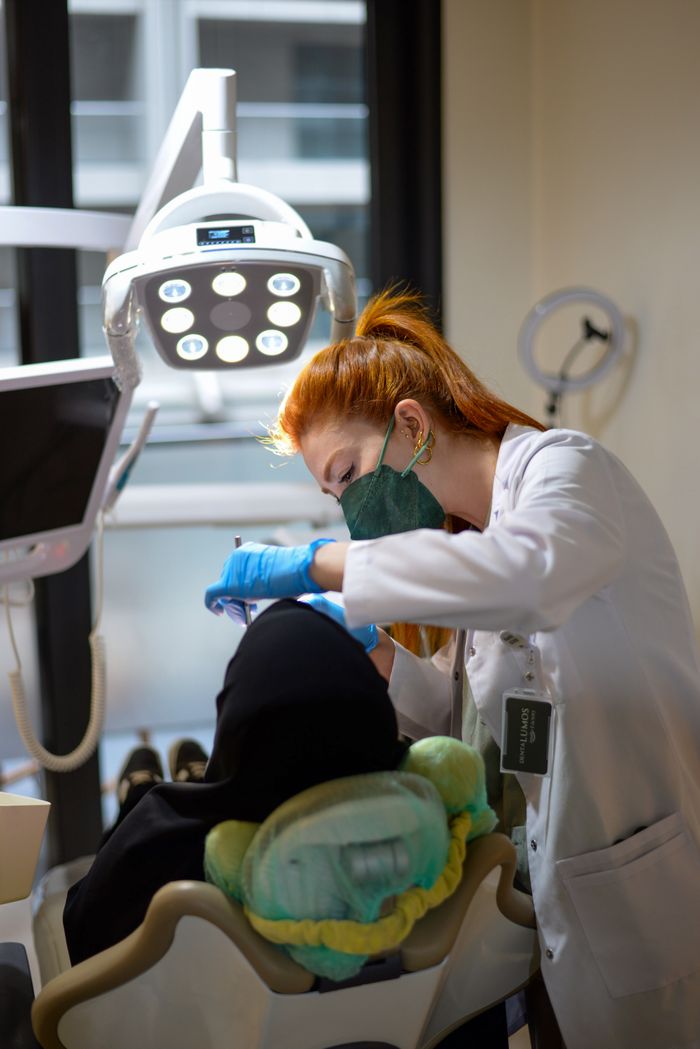 journey-01 Dentist performing a dental checkup on a patient in a bright, modern clinic.